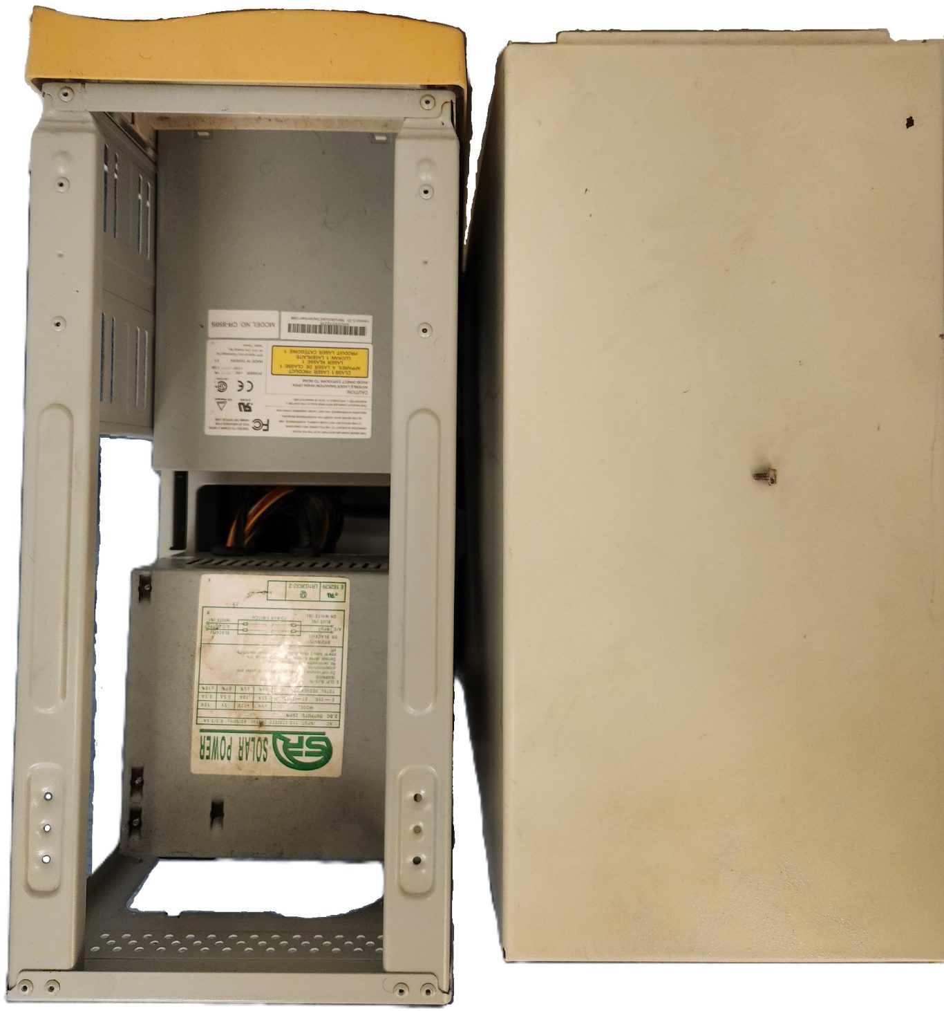 The computer after restoration (Top view). A gray electronic device with an open front panel, revealing internal components.