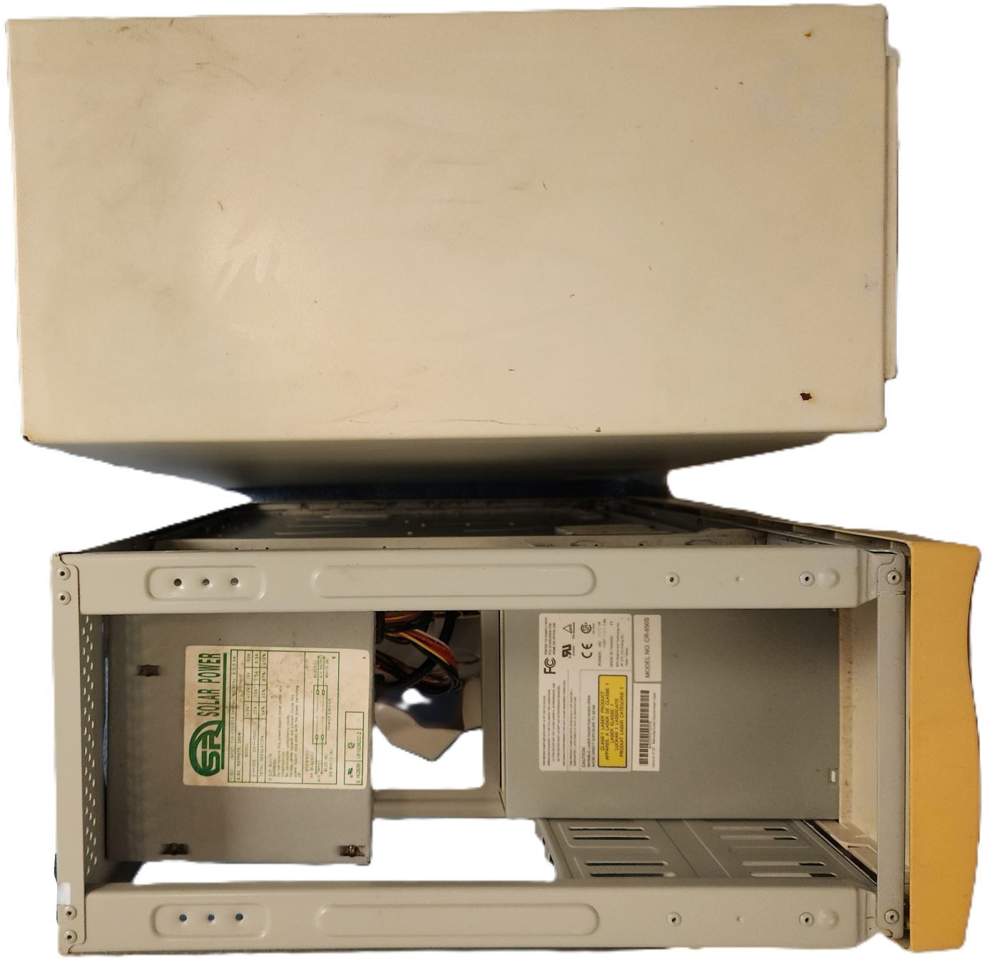The computer before applying restoration techniques on it (Top View). A disassembled computer tower with exposed internal components.