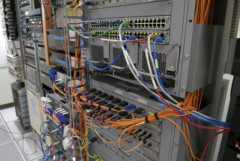 server support Close-up of a server rack with colorful cables and networking equipment.