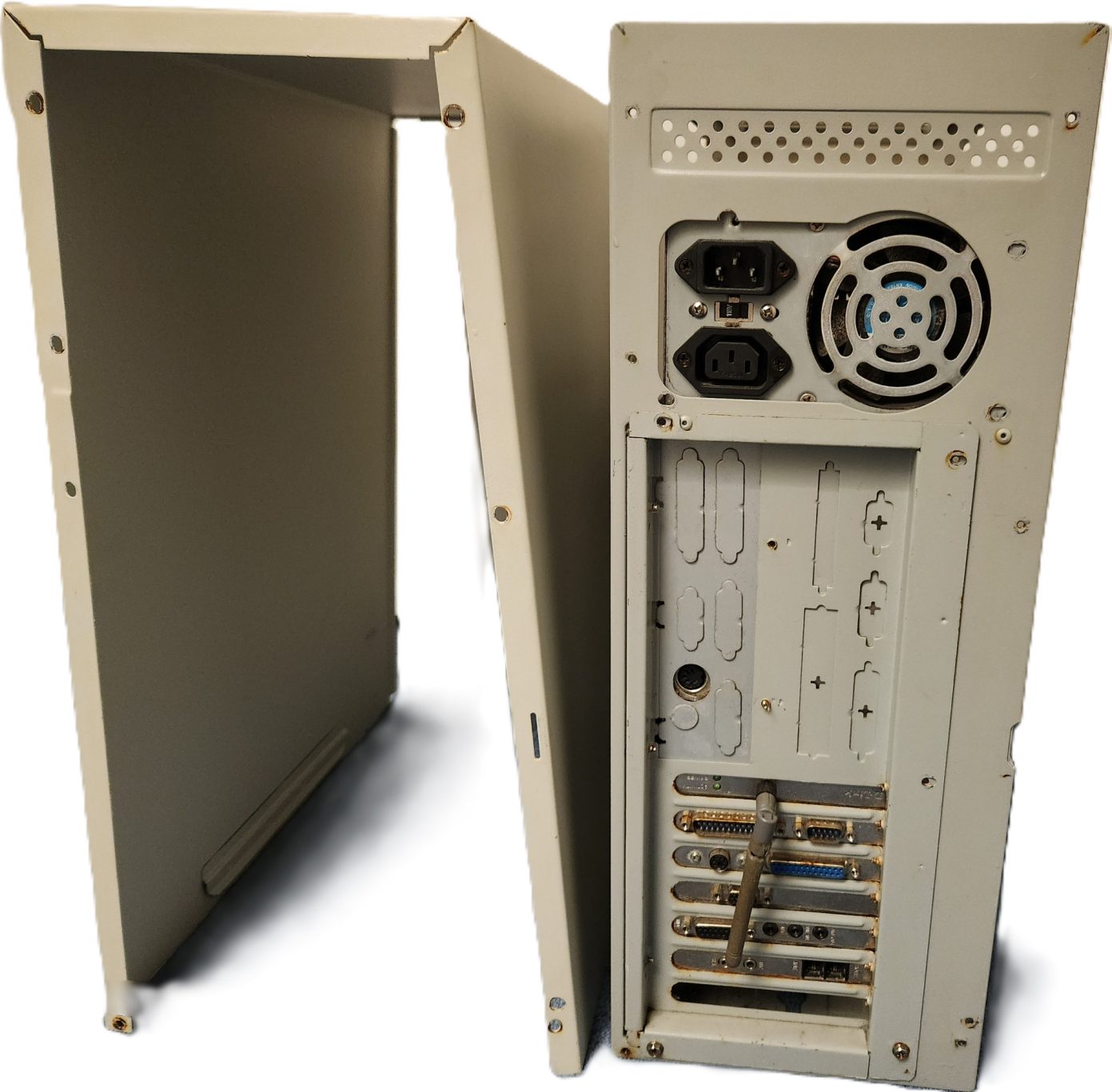 The computer before applying restoration techniques on it (Rear View). Computer case with a side panel removed, showing ports and internal structure.